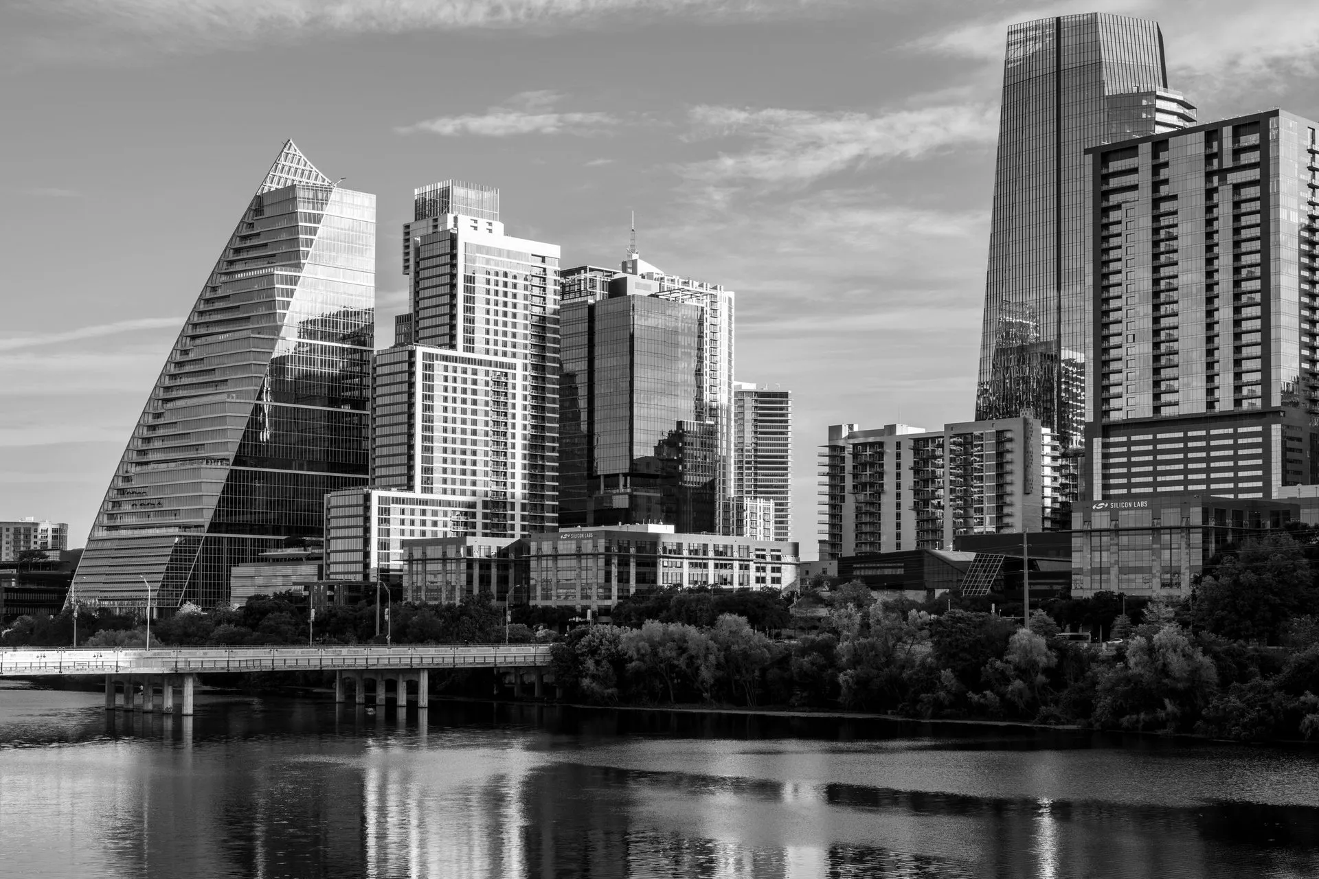 Black and white view of Austin's modern skyline with reflections on water