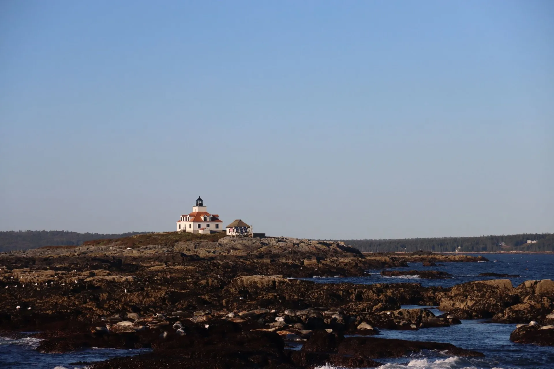 View of a traditional coastal lighthouse on a rocky shore in Bar Harbor