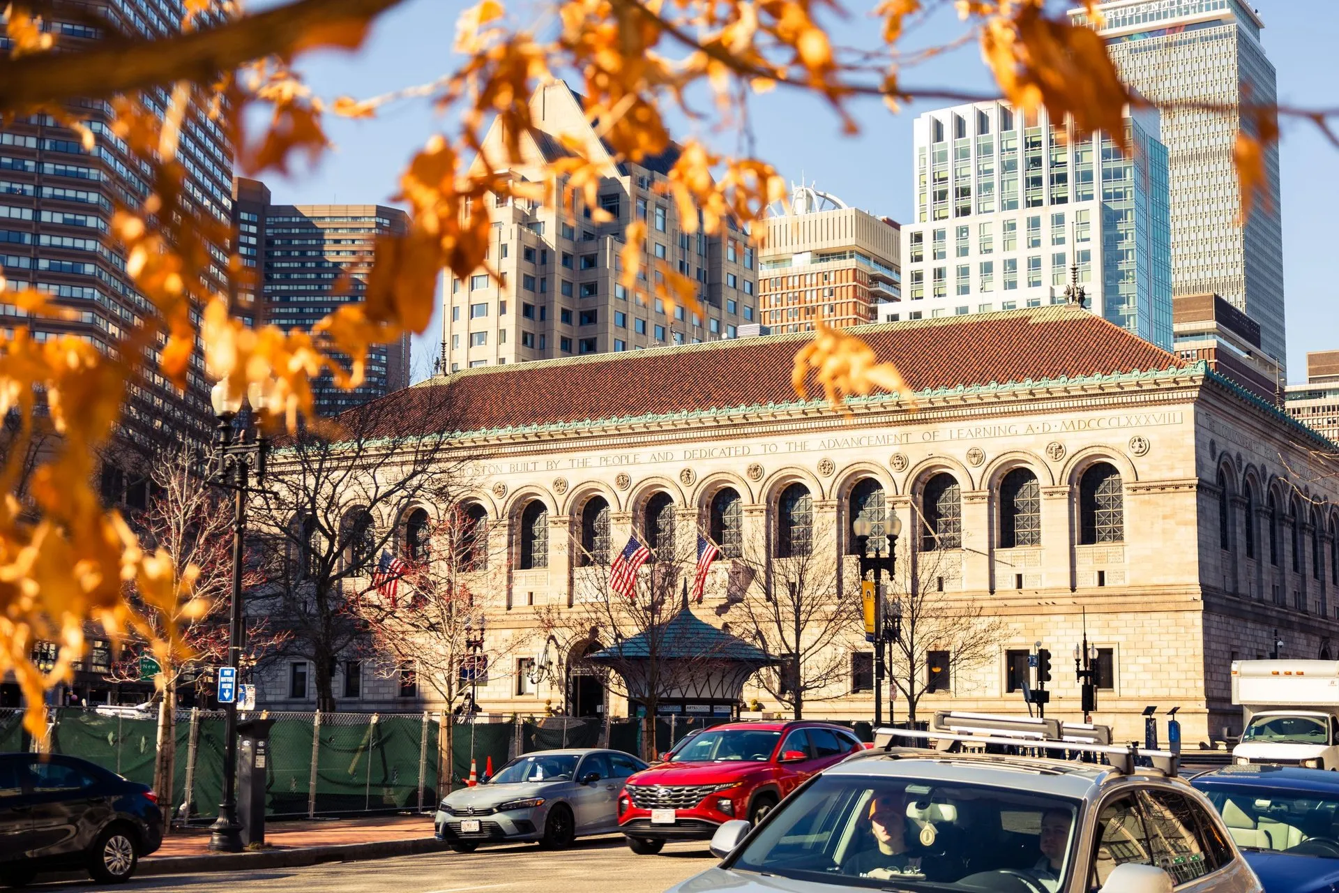 Historic Boston Public Library framed by autumn leaves