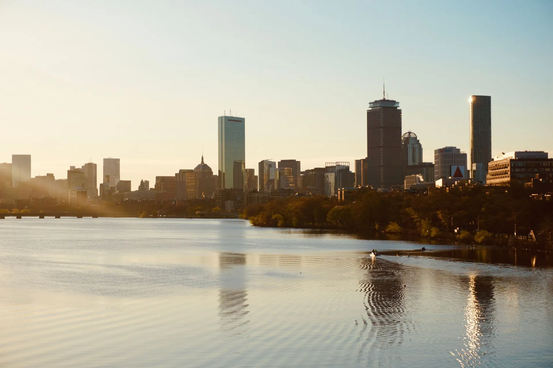 View of Boston skyline at sunset, highlighting cityscape and tranquil water