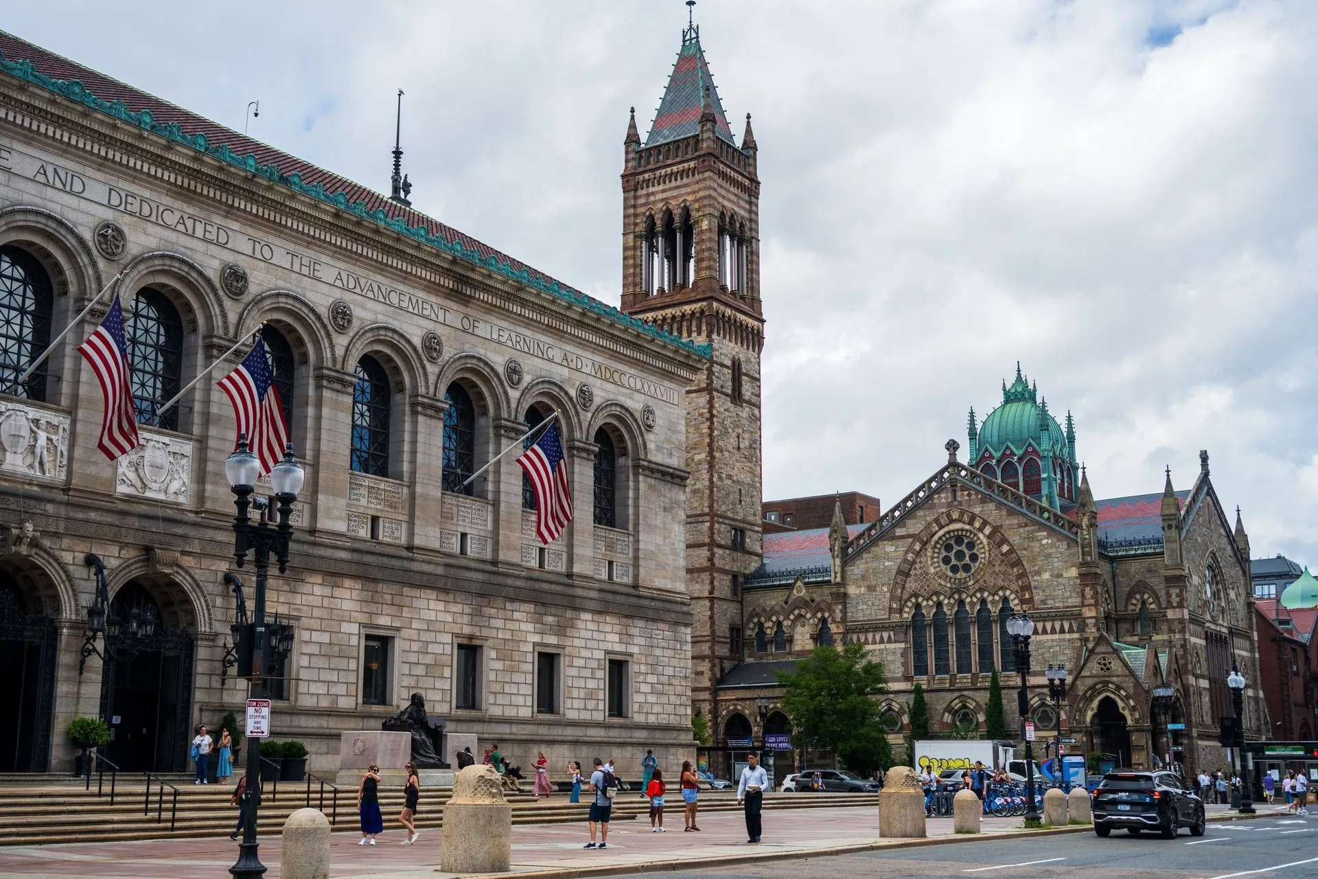 Boston Public Library and Trinity Church facade on a bustling day