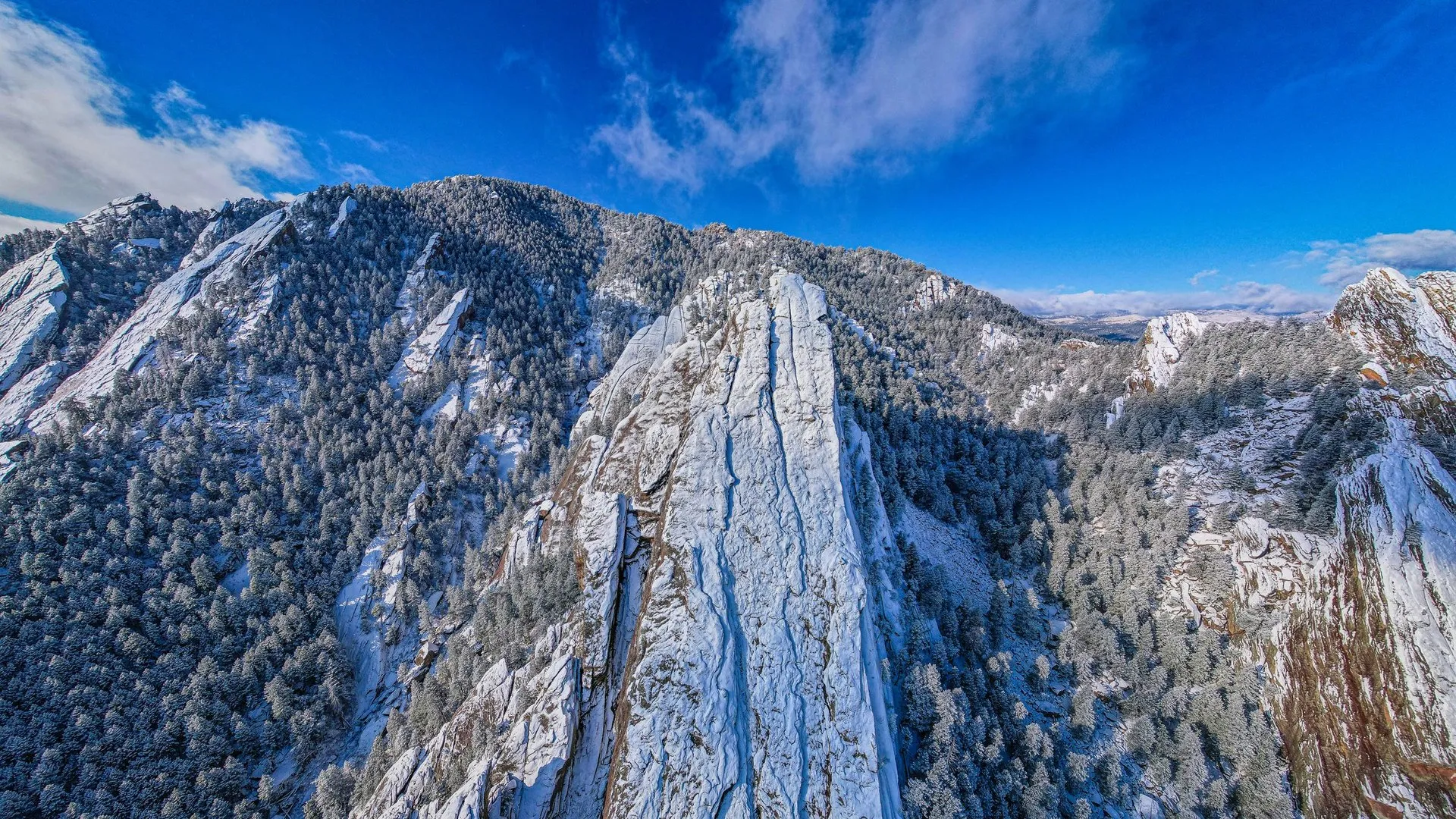 Aerial view of the snow-covered Flatirons in Boulder, Colorado
