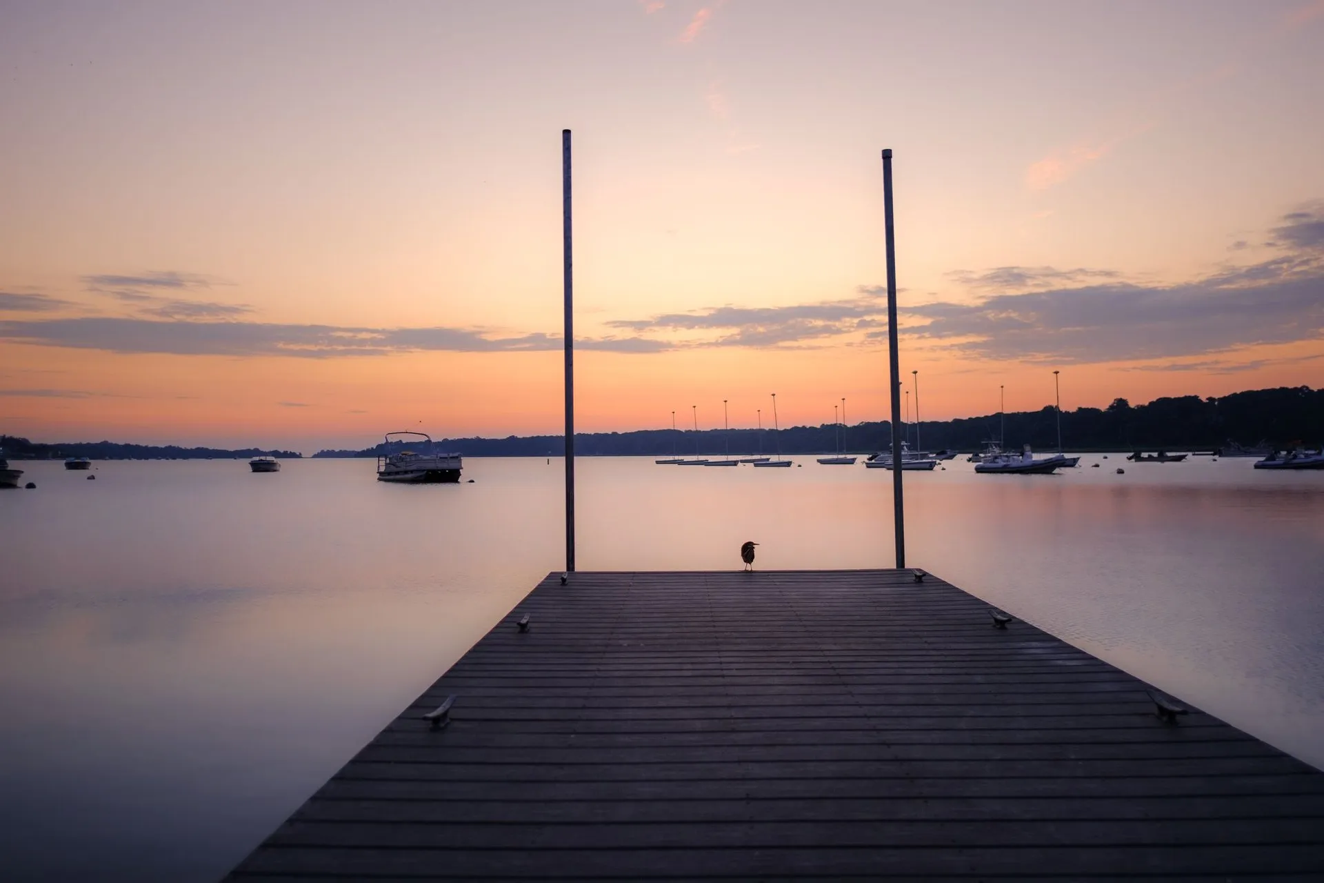 View of a pier and calm waters at sunset in Orleans, Cape Cod, MA