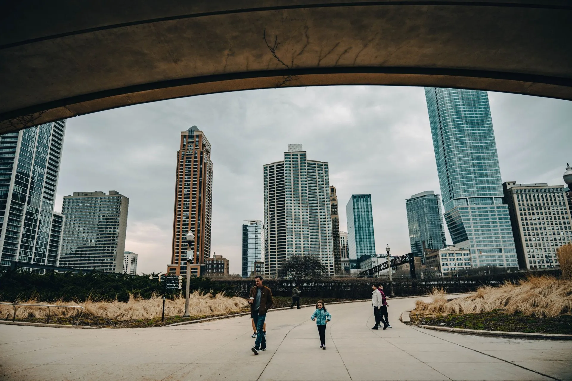 View of Chicago's skyscrapers with people walking in an urban park setting