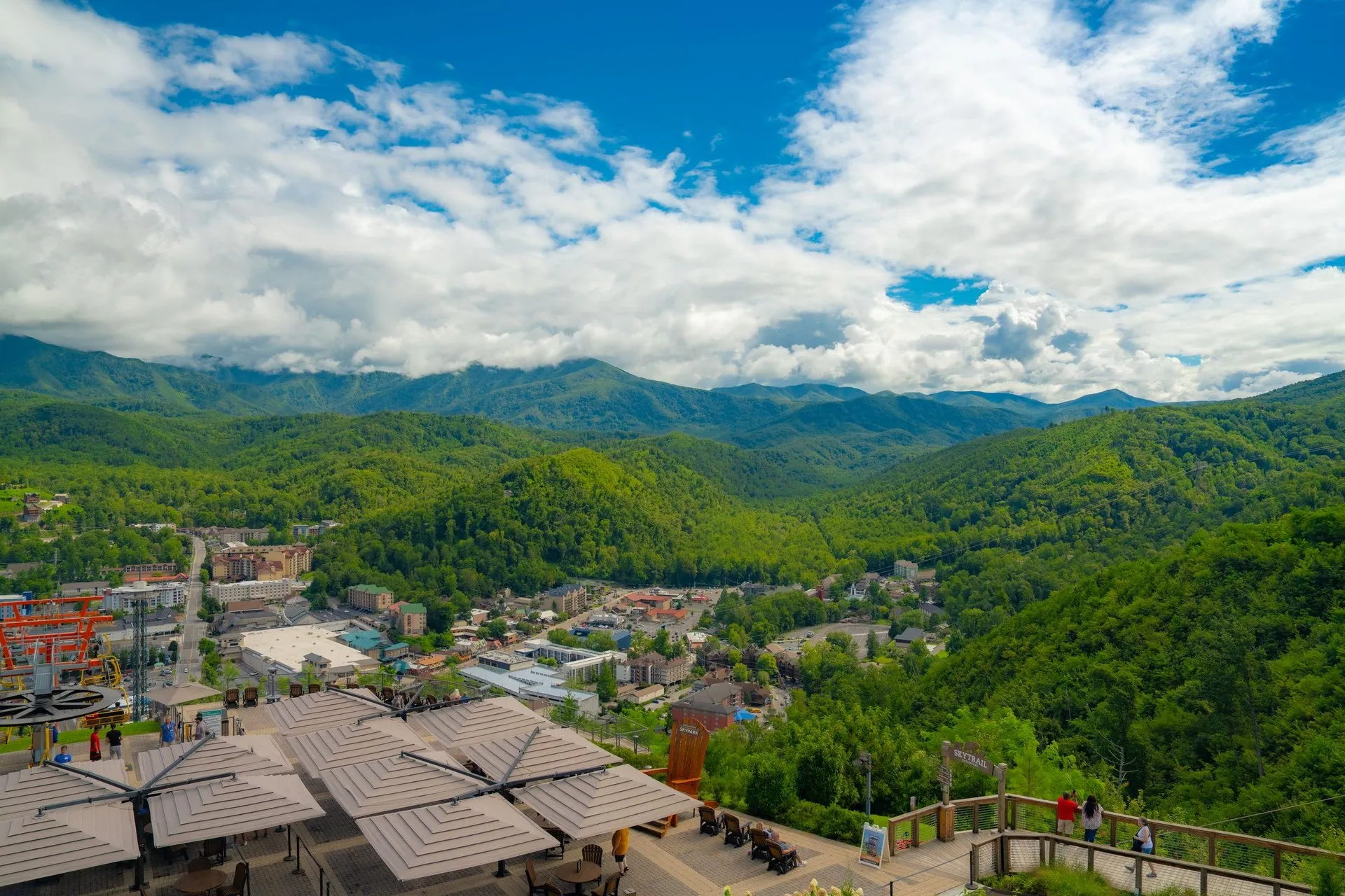 Aerial view of lush Smoky Mountains and Gatlinburg cityscape during summer