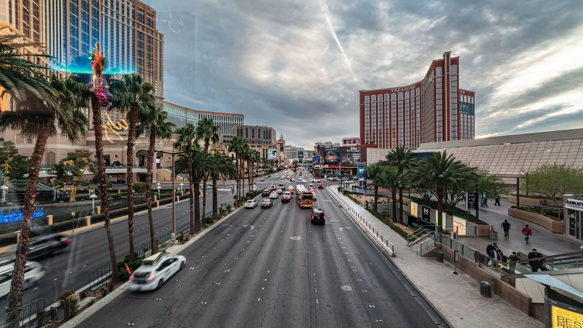 Dynamic view of the bustling Las Vegas Strip featuring traffic, palm trees