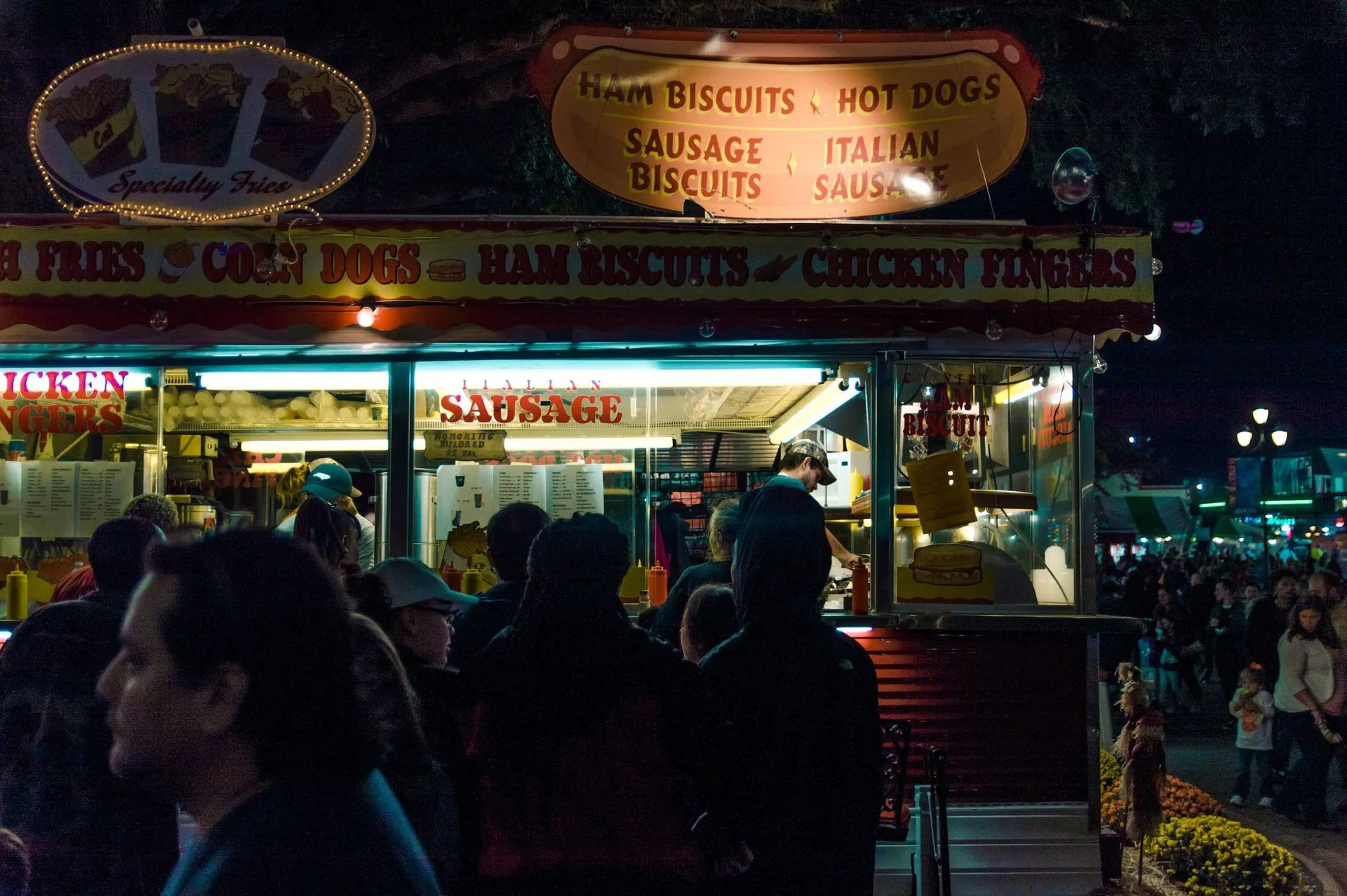 A bustling street food booth in Raleigh at night