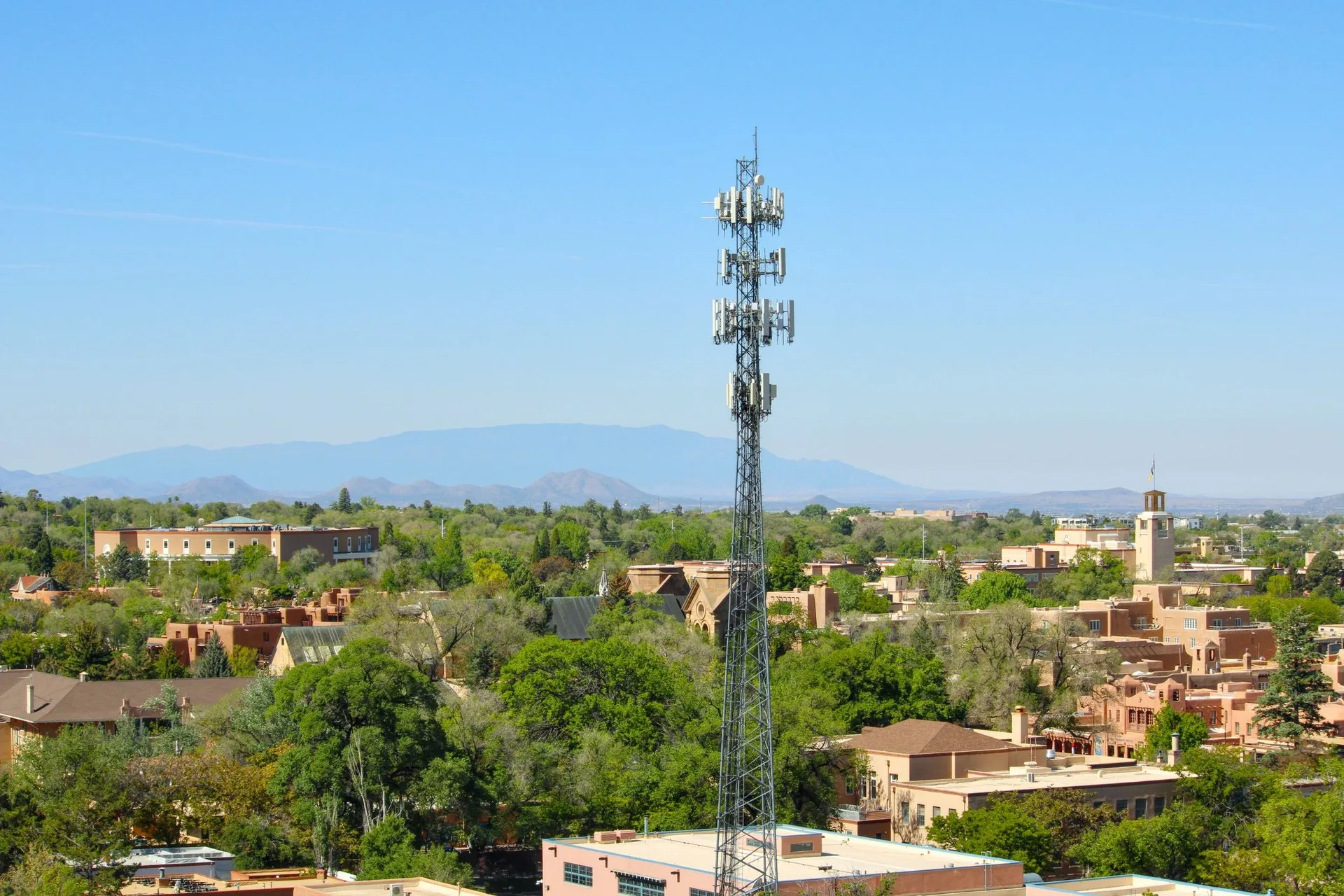 Aerial view of Santa Fe, NM, featuring a cell tower and classic adobe