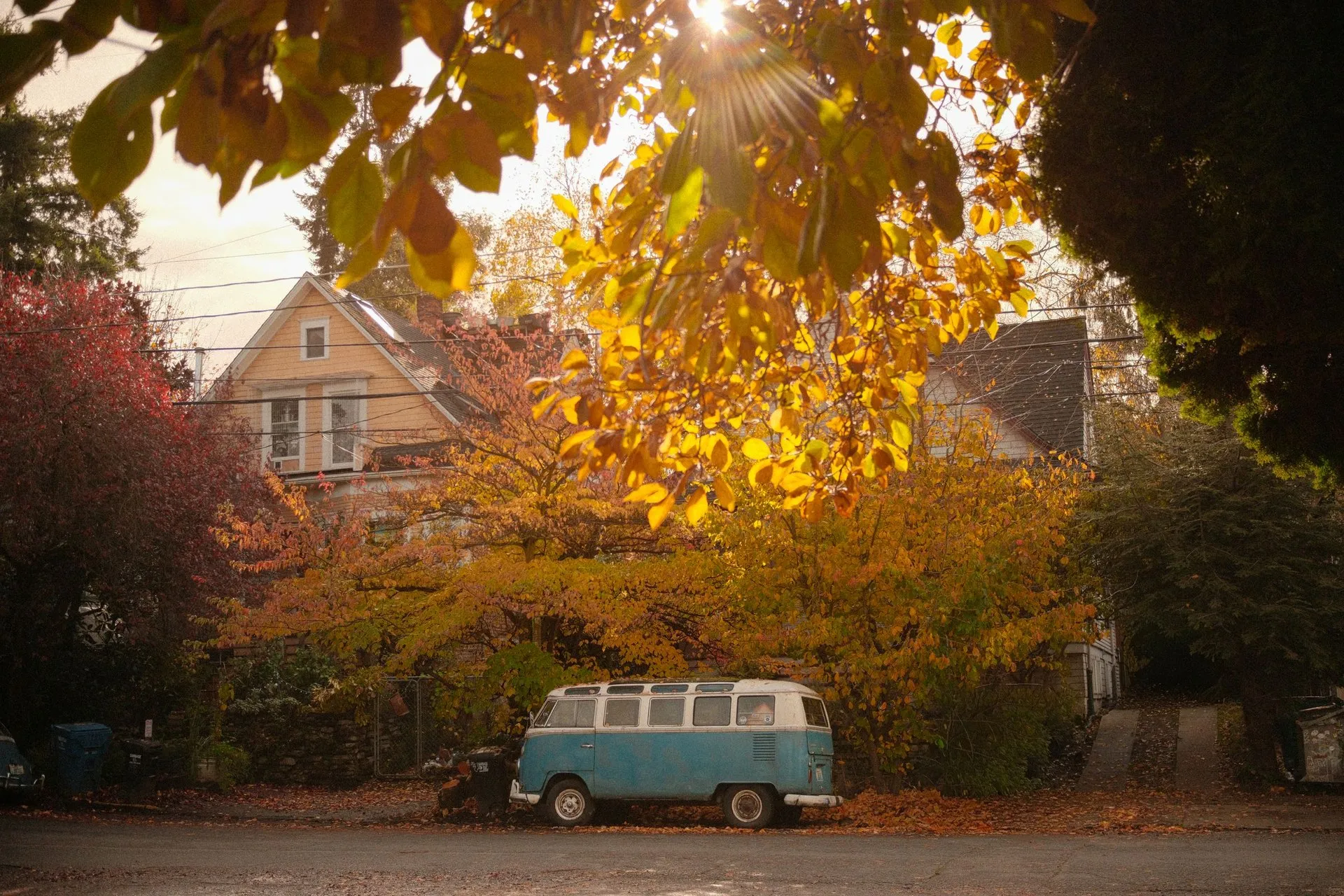 Vintage Volkswagen bus on a picturesque Seattle street with autumn foliage