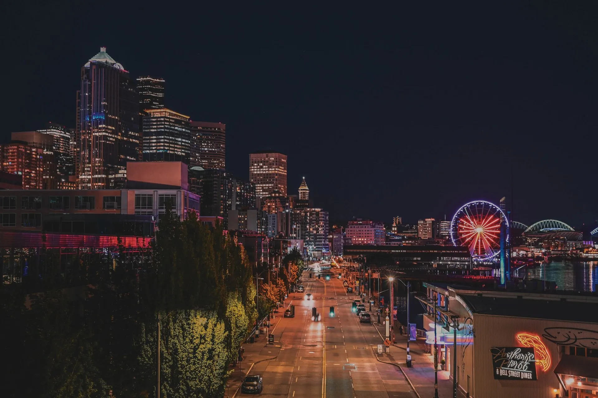 Seattle's vibrant skyline and iconic Ferris wheel illuminated