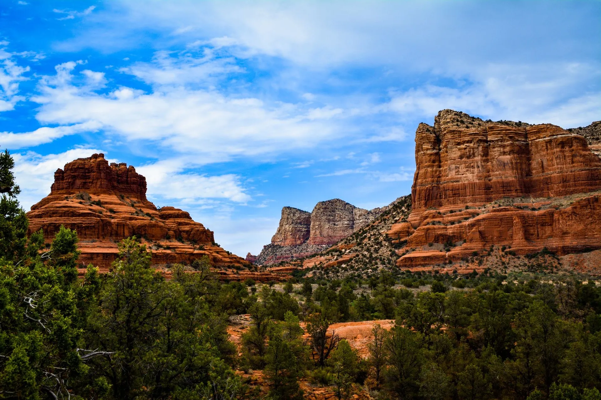 View of Sedona's iconic red rock formations under a vibrant blue sky