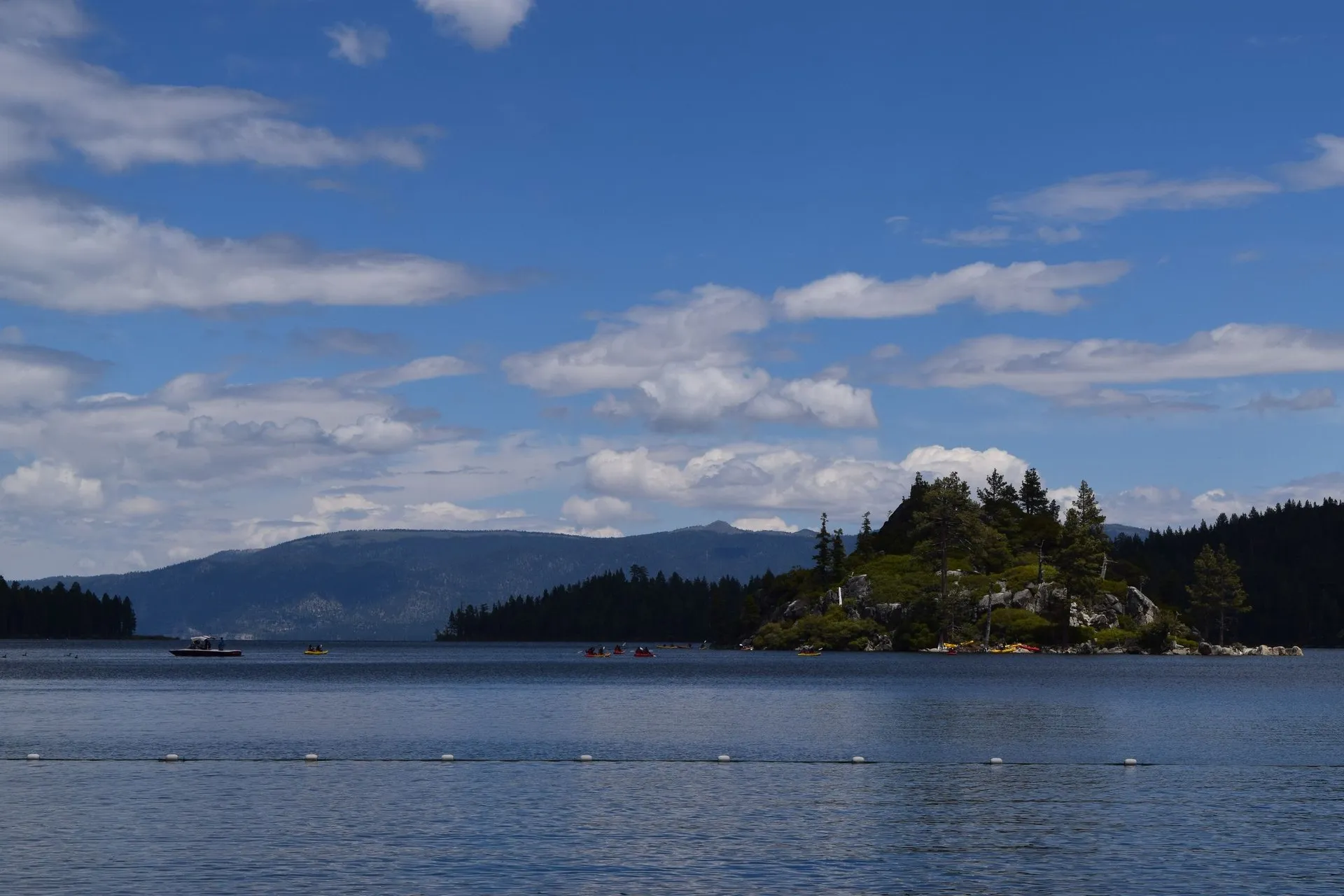 Summer landscape of South Lake Tahoe with coniferous island and mountains