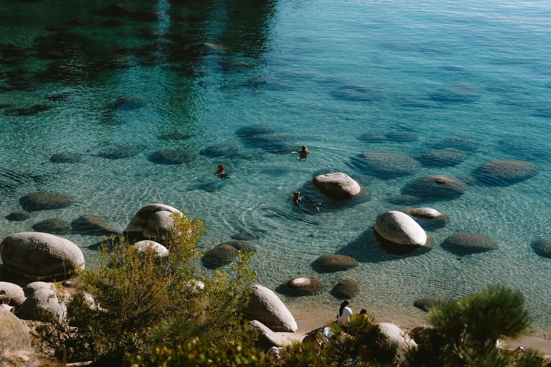 Aerial view of people swimming in the clear waters of South Lake Tahoe